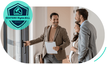A stock image of a letting agent in his 30s showing a similarly aged expectant couple into a property. Everyone is wearing smart-casual attire and is smiling.  